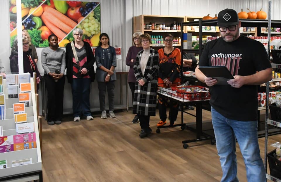 photo of Jason Moore (right) speaks during the grand opening ceremony for the new client choice shopping model at the Moose Jaw & District Food Bank on Oct. 28, 2024